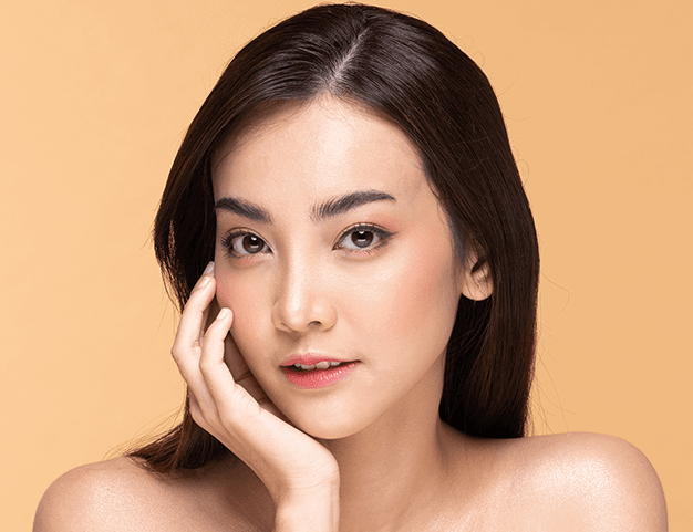 woman posing with her hand against her jaw